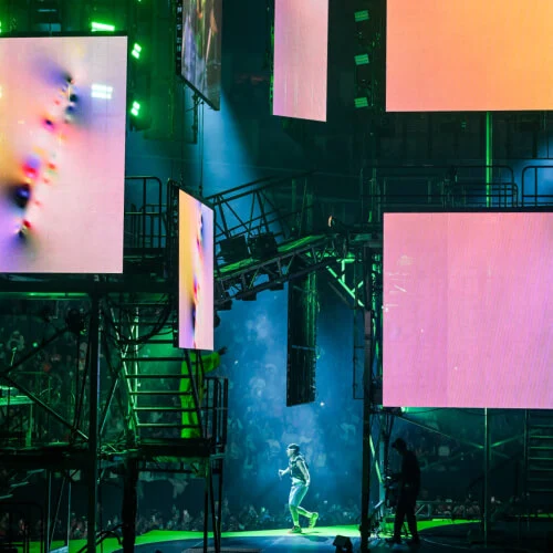 Large LED screens showing artowrks at concert.